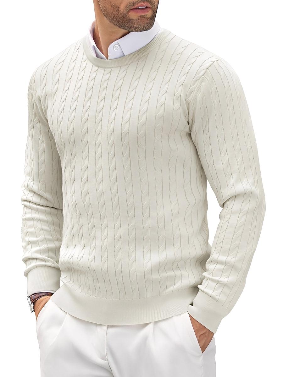 Man wearing a cream cable knit sweater over a white shirt with a white background