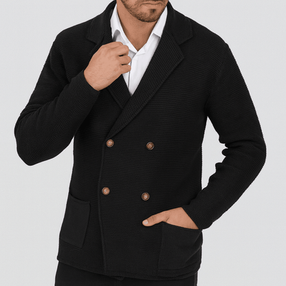 Man wearing a black double-breasted blazer on a light gray background