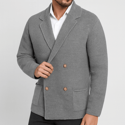 Gray blazer with gold buttons worn by a person on a light gray background